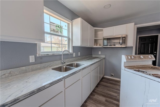 kitchen with white cabinetry, sink, white range, light stone counters, and dark hardwood / wood-style floors