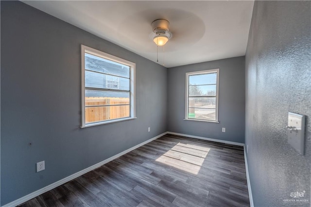 empty room with ceiling fan and dark wood-type flooring