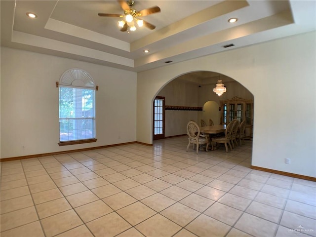 9401 N Fm 1015, Mercedes, TX 78570 - unfurnished room featuring a raised ceiling, arched walkways, baseboards, a ceiling fan, and recessed lighting