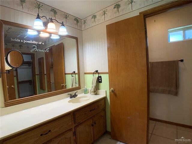 9401 N Fm 1015, Mercedes, TX 78570 - bathroom featuring vanity, a chandelier, tile patterned flooring, and baseboards
