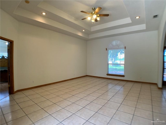 9401 N Fm 1015, Mercedes, TX 78570 - empty room with a raised ceiling, a ceiling fan, baseboards, recessed lighting, and light tile patterned floors