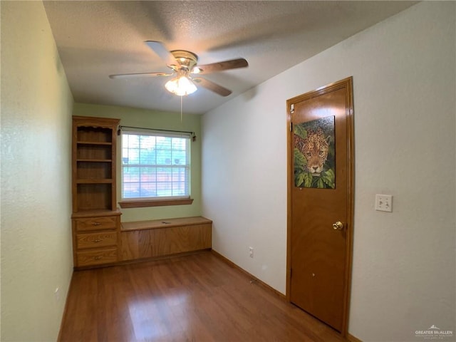 9401 N Fm 1015, Mercedes, TX 78570 - spare room with wood finished floors, a ceiling fan, baseboards, and a textured ceiling