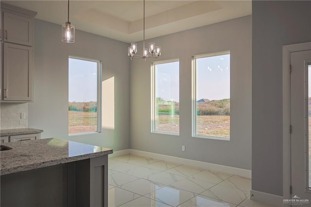 3000 E Tamarindo Ave, Hidalgo, TX 78557 - unfurnished dining area featuring a chandelier and a raised ceiling