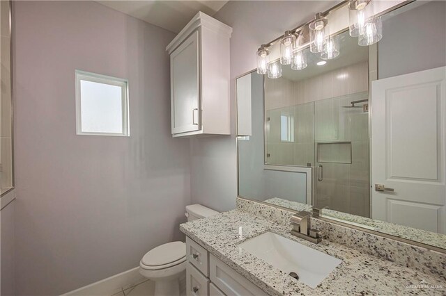 bathroom with vanity, toilet, and an enclosed shower