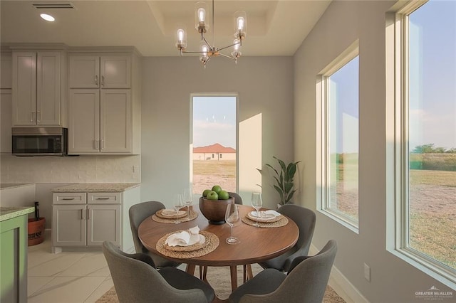 3000 E Tamarindo Ave, Hidalgo, TX 78557 - dining area with a chandelier, healthy amount of natural light, and light tile patterned floors