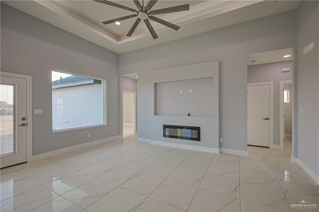 unfurnished living room with ceiling fan