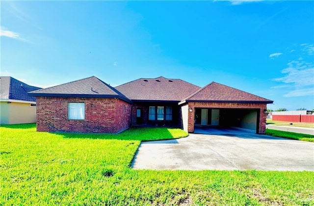 ranch-style home featuring a garage and a front lawn