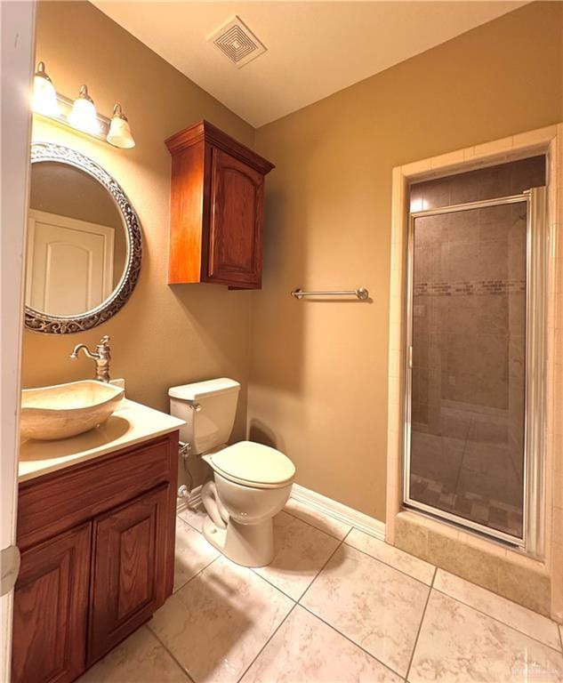 bathroom featuring tile patterned floors, vanity, toilet, and walk in shower