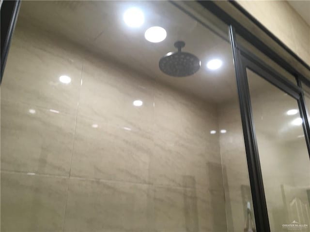 interior details featuring tiled shower