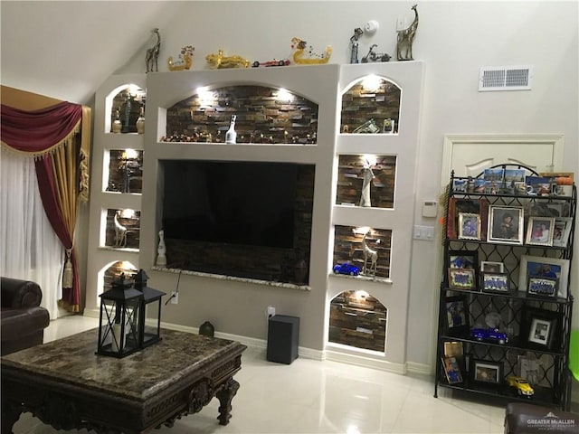 tiled living area with vaulted ceiling, visible vents, and baseboards