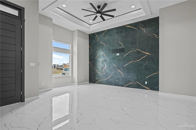 unfurnished room featuring crown molding, ceiling fan, and a tray ceiling