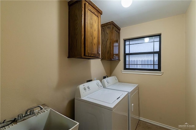 laundry room with washer and clothes dryer, cabinets, and sink