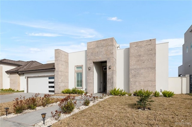 modern home featuring a garage and concrete driveway