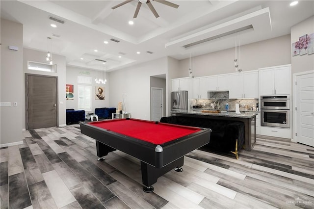 recreation room featuring baseboards, visible vents, a towering ceiling, ceiling fan, and recessed lighting