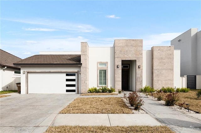 contemporary home featuring concrete driveway and an attached garage