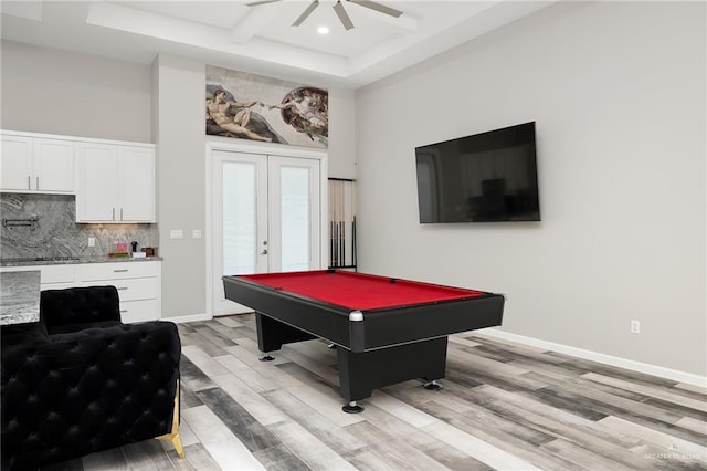 playroom featuring baseboards, coffered ceiling, light wood-style flooring, french doors, and recessed lighting