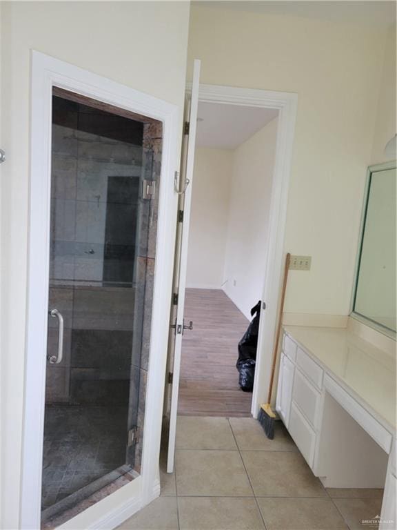 bathroom featuring vanity, a shower with shower door, and hardwood / wood-style flooring