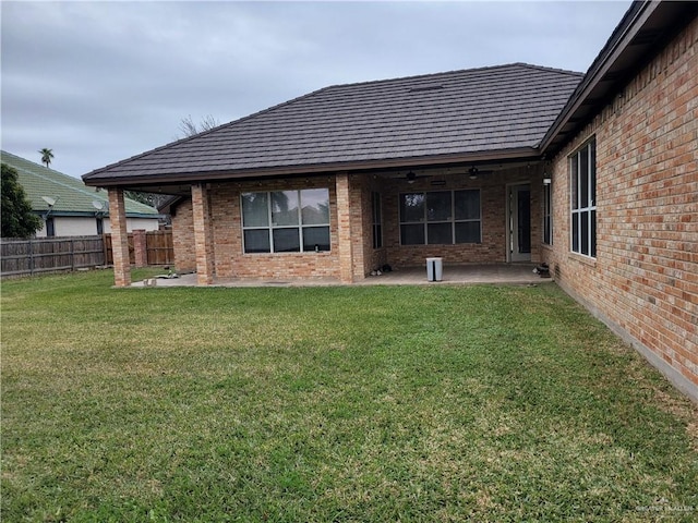 rear view of house featuring a yard and a patio area