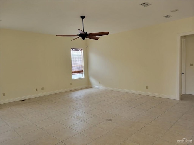 spare room featuring light tile patterned floors and ceiling fan