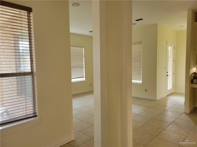 hall featuring light tile patterned floors