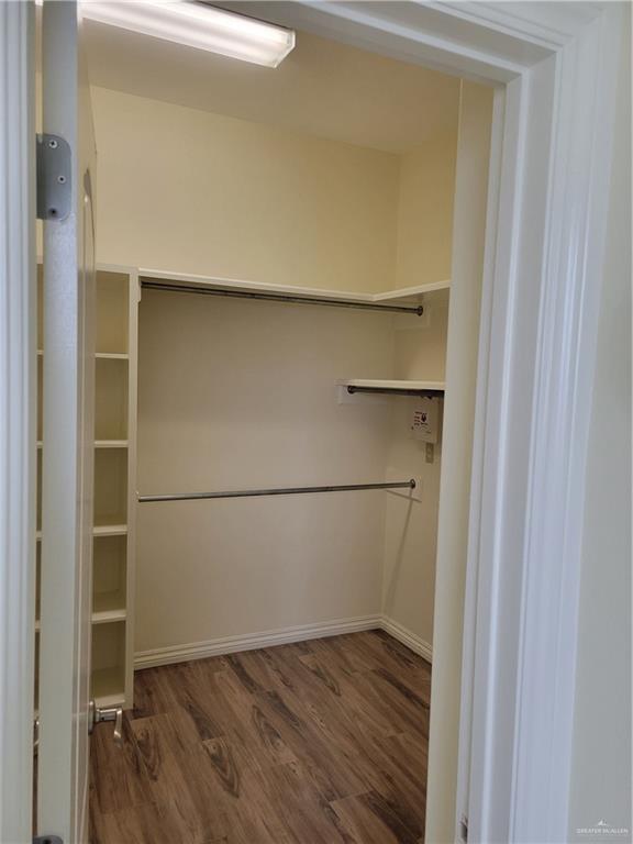 spacious closet featuring hardwood / wood-style floors