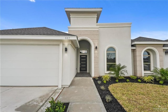 entrance to property with a lawn and a garage