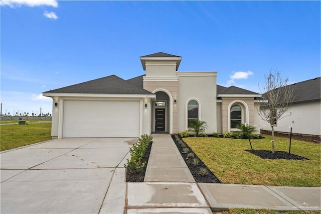 view of front of property featuring a front yard and a garage