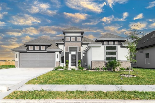 3804 Crimson Ave, Mission, TX 78574 - prairie-style home featuring concrete driveway, stucco siding, stone siding, a garage, and a yard