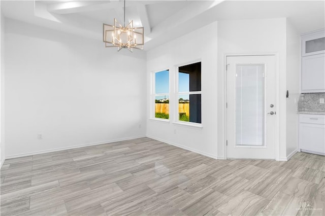 3804 Crimson Ave, Mission, TX 78574 - empty room featuring baseboards, light wood-type flooring, an inviting chandelier, beamed ceiling, and coffered ceiling
