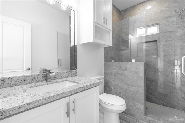 3804 Crimson Ave, Mission, TX 78574 - bathroom featuring toilet, a stall shower, and vanity