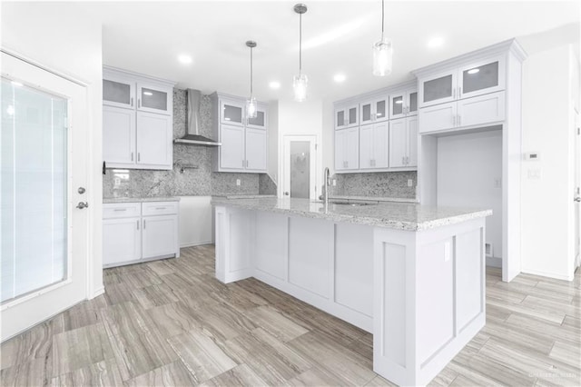 3804 Crimson Ave, Mission, TX 78574 - kitchen featuring a sink, white cabinets, wall chimney exhaust hood, and decorative backsplash