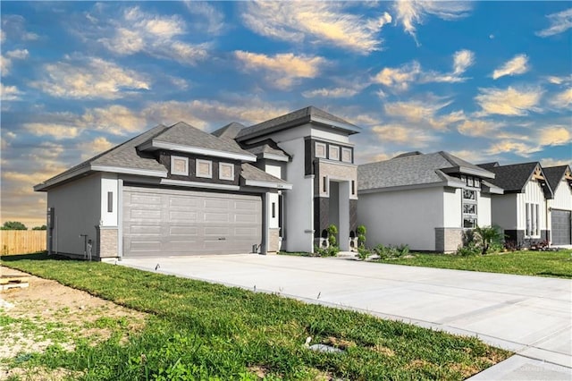 3804 Crimson Ave, Mission, TX 78574 - prairie-style home with a front yard, an attached garage, concrete driveway, fence, and stucco siding