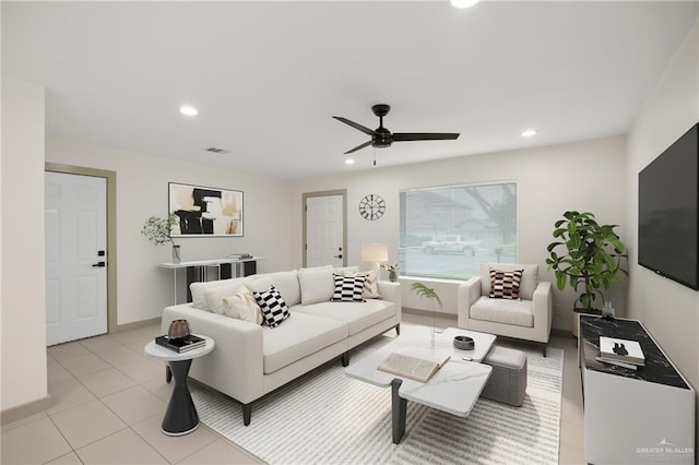 living room featuring light tile patterned floors and ceiling fan