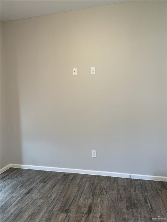 spare room featuring dark hardwood / wood-style flooring