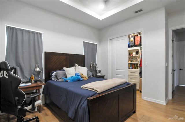 bedroom with a closet and light hardwood / wood-style floors