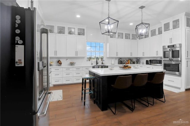 kitchen featuring white cabinets, stainless steel appliances, and a kitchen island