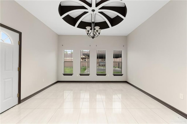 empty room featuring light tile patterned floors and a chandelier