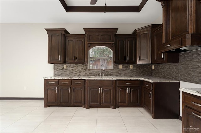 kitchen featuring dark brown cabinets, ceiling fan, sink, and tasteful backsplash