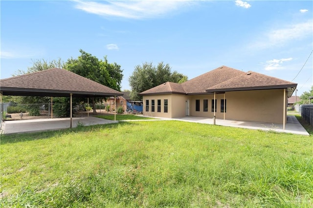 rear view of property featuring a gazebo, a yard, and a patio