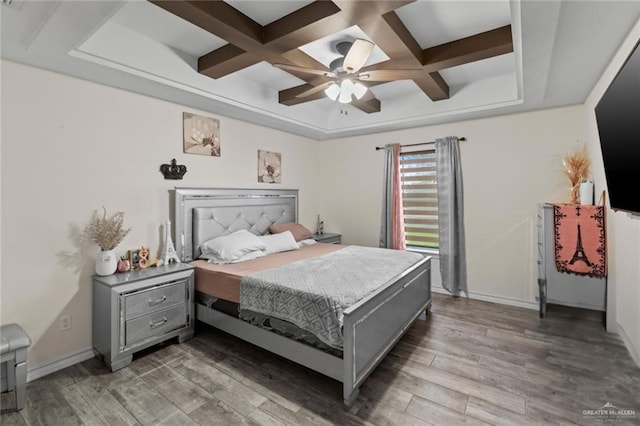 bedroom featuring hardwood / wood-style floors, ceiling fan, beam ceiling, and coffered ceiling