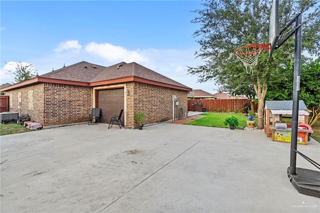 view of home's exterior featuring a lawn, central AC unit, and a garage