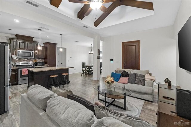 living room featuring ceiling fan and light hardwood / wood-style flooring