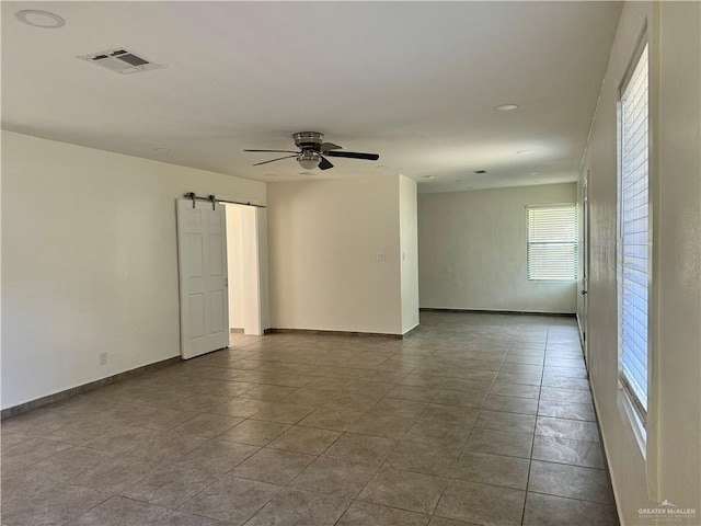 808 Tennessee Ave, Weslaco, TX 78596 - unfurnished room featuring a barn door and a ceiling fan