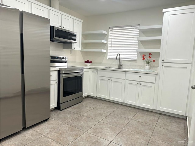 808 Tennessee Ave, Weslaco, TX 78596 - kitchen featuring stainless steel appliances, open shelves, light countertops, and light tile patterned flooring