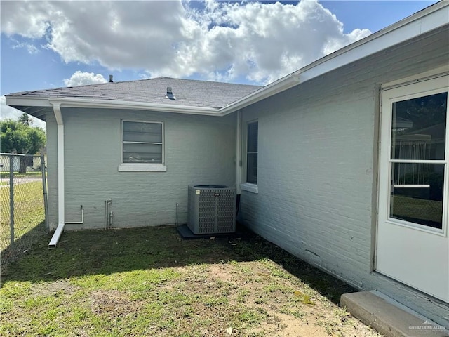 808 Tennessee Ave, Weslaco, TX 78596 - view of property exterior featuring a central air condition unit and roof with shingles