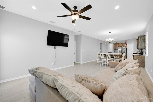 living room featuring ceiling fan and light hardwood / wood-style floors