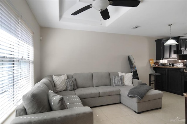 living room with ceiling fan and light tile patterned flooring