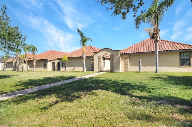 mediterranean / spanish-style home with a front lawn