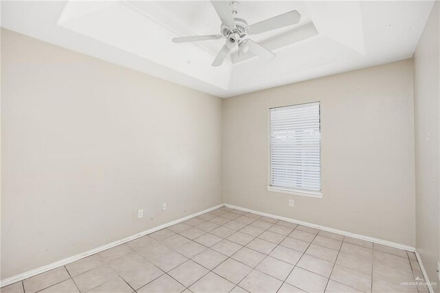 1504 Prosperity Dr, Edinburg, TX 78541 - spare room with a tray ceiling, a ceiling fan, baseboards, and light tile patterned flooring