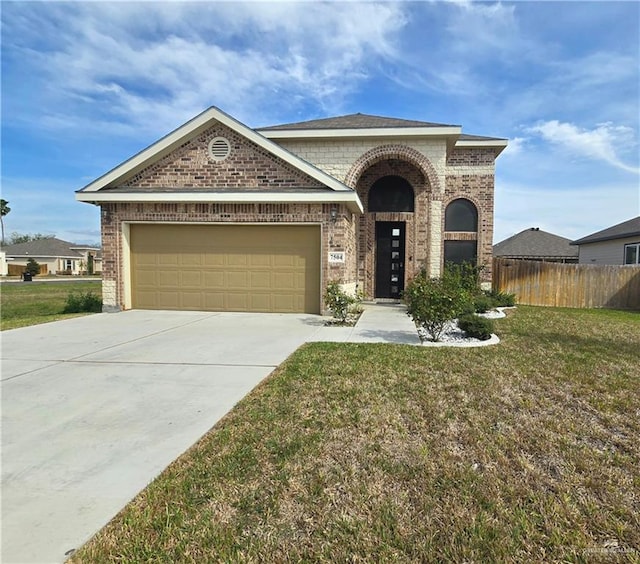 view of front of home with a garage, brick siding, fence, concrete driveway, and a front yard